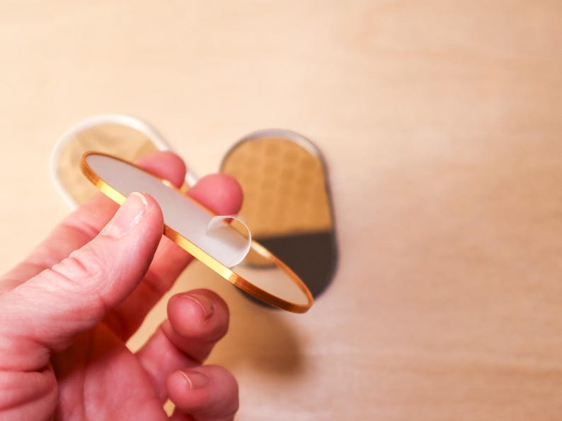 Gold pill shaped dollhouse mirror with protective film