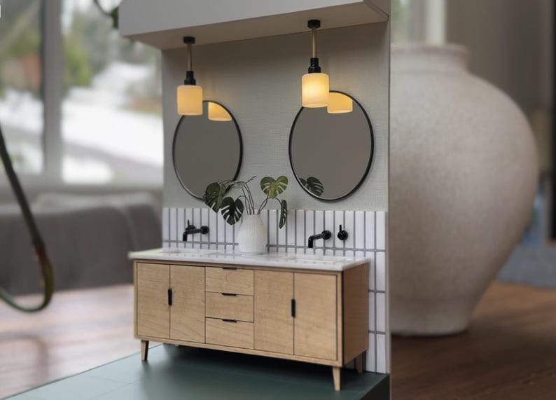 Oval mirrors above dollhouse bathroom double vanity