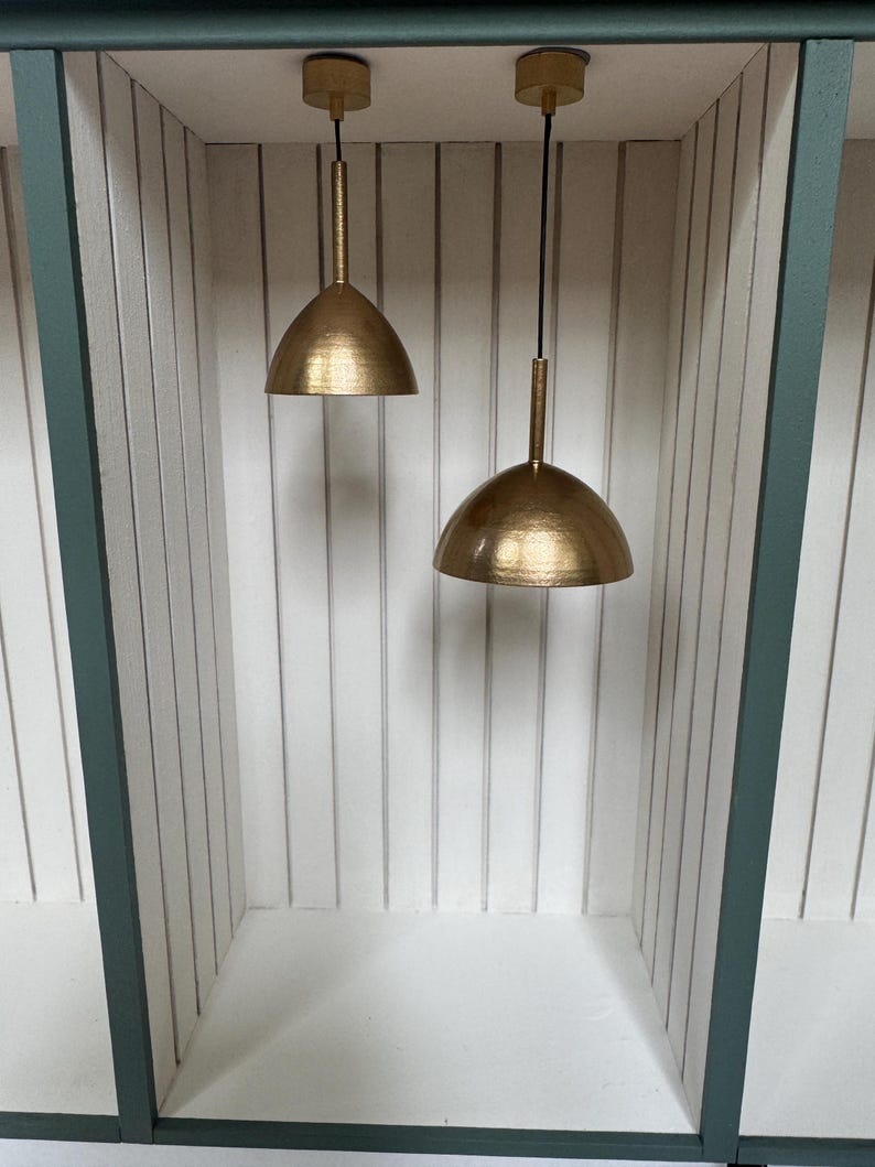 Gold pendant lights in dollhouse alcove