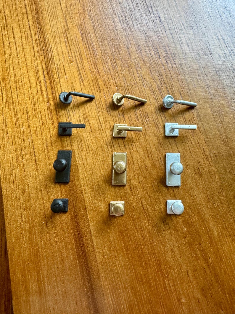 Grid of twelve miniature door hardware pieces