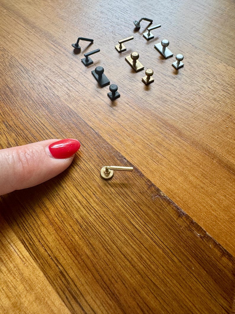 Collection of miniature door handles and knobs