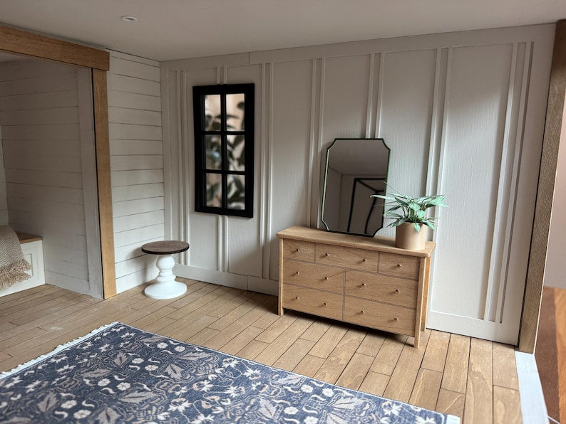 Dollhouse bedroom scene with mirror and dresser