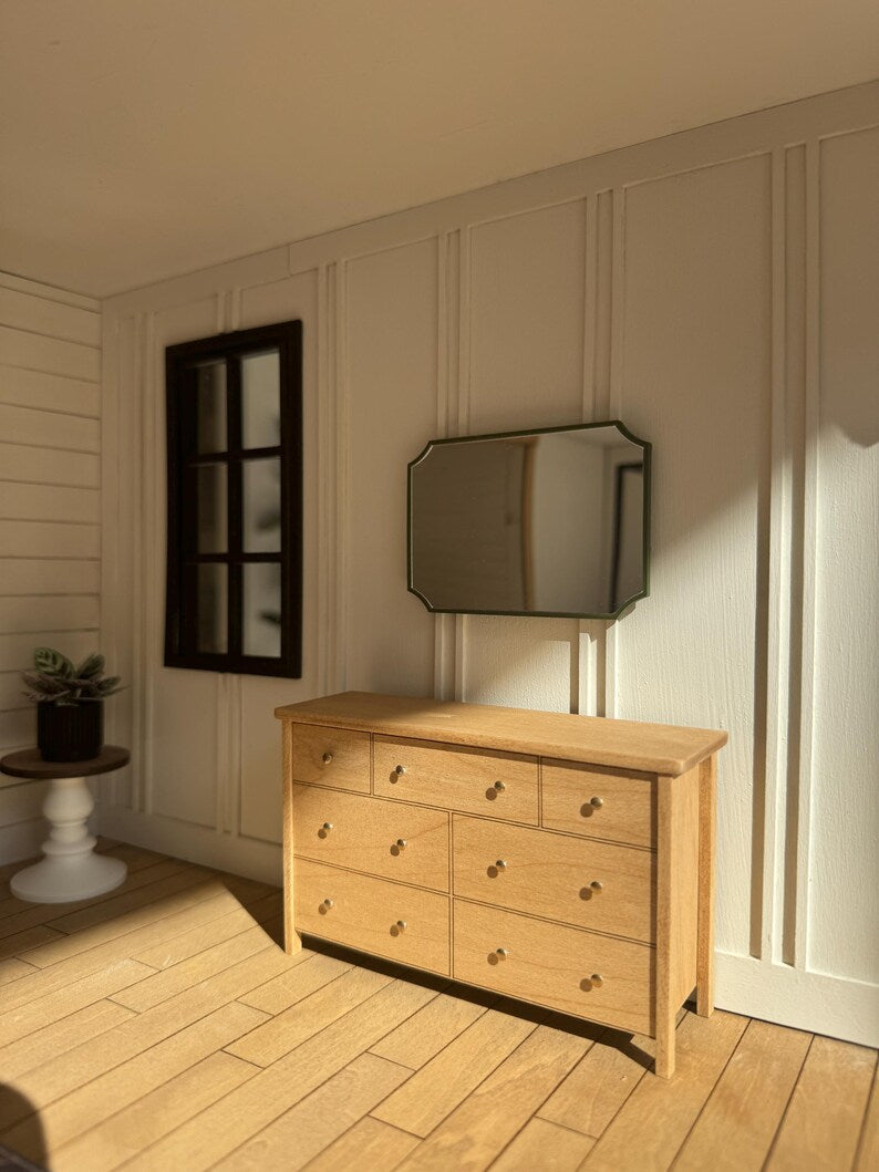 Dollhouse dresser with mirror near window